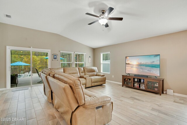 living room featuring light wood-type flooring, ceiling fan, and vaulted ceiling