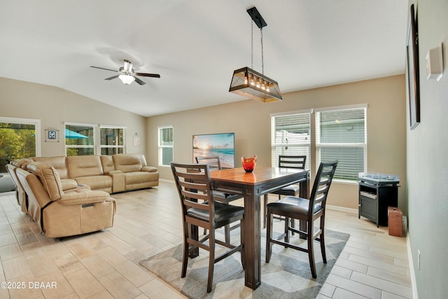 dining space with a healthy amount of sunlight, vaulted ceiling, and ceiling fan