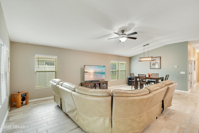 living room featuring ceiling fan and vaulted ceiling