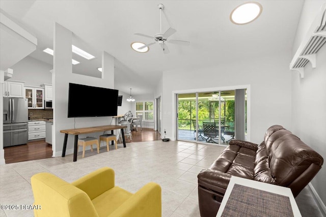 5935 Shady Creek Ln, Port Orange, FL 32128 - living room featuring light tile patterned flooring, a ceiling fan, and high vaulted ceiling