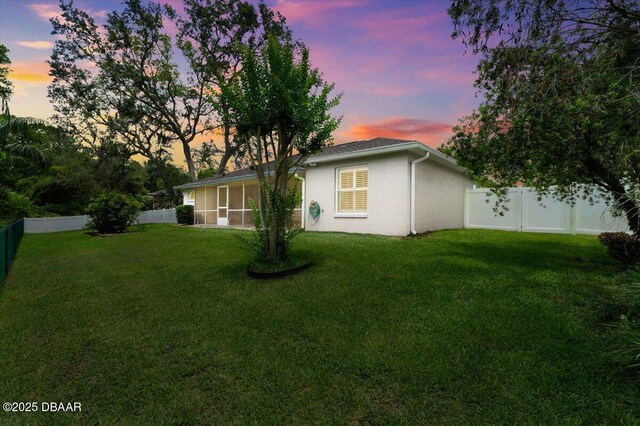 5935 Shady Creek Ln, Port Orange, FL 32128 - view of side of home with a sunroom and stucco siding
