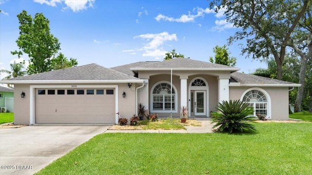 5935 Shady Creek Ln, Port Orange, FL 32128 - view of front of house featuring a front yard, an attached garage, stucco siding, and concrete driveway