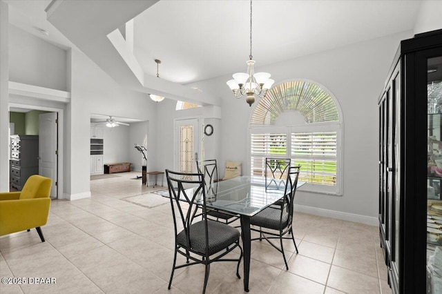 5935 Shady Creek Ln, Port Orange, FL 32128 - dining area with light tile patterned floors, a chandelier, baseboards, a ceiling fan, and a high ceiling