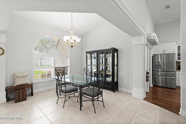 5935 Shady Creek Ln, Port Orange, FL 32128 - dining room featuring light tile patterned floors, a chandelier, and baseboards