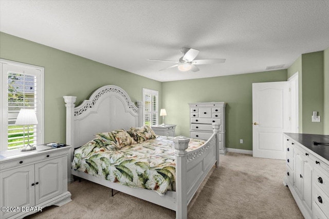 5935 Shady Creek Ln, Port Orange, FL 32128 - bedroom with light carpet, a textured ceiling, ceiling fan, and baseboards