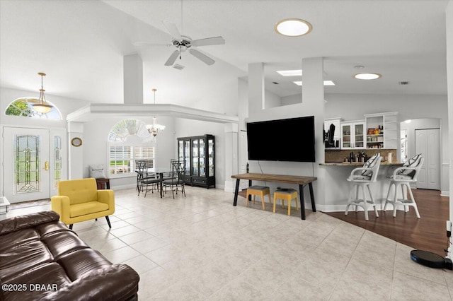 5935 Shady Creek Ln, Port Orange, FL 32128 - living room featuring a ceiling fan, tile patterned flooring, a chandelier, and high vaulted ceiling