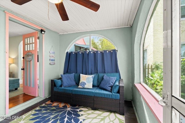 sunroom featuring ceiling fan