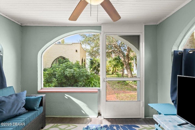 interior space with a sunroom, a healthy amount of sunlight, and wood finished floors