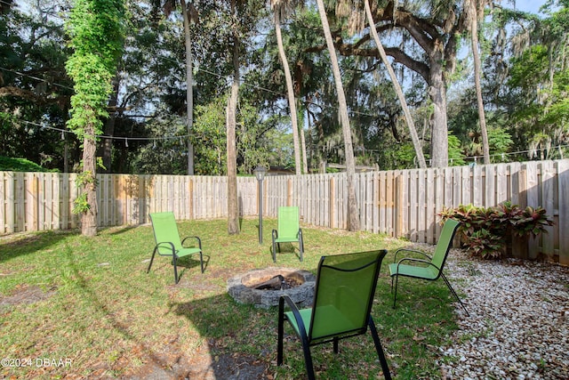 view of yard featuring an outdoor fire pit