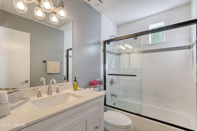 full bathroom with toilet, combined bath / shower with glass door, and vanity