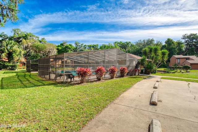 view of yard featuring glass enclosure and a swimming pool