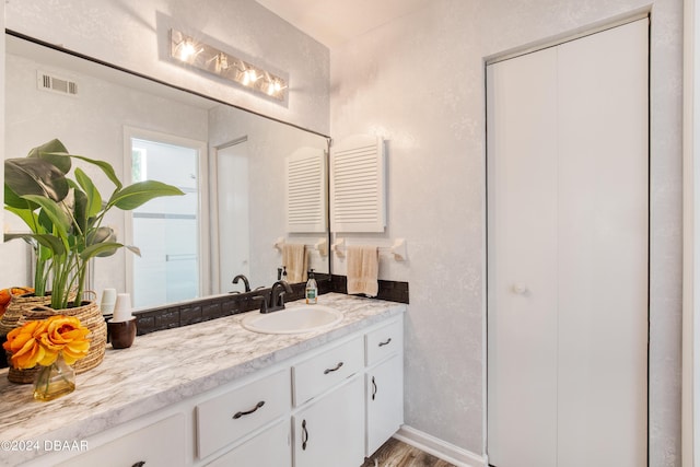 bathroom with vanity and hardwood / wood-style flooring