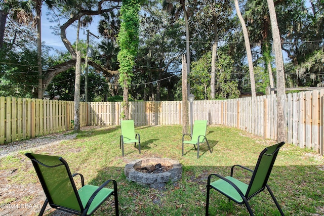 view of yard with a fire pit