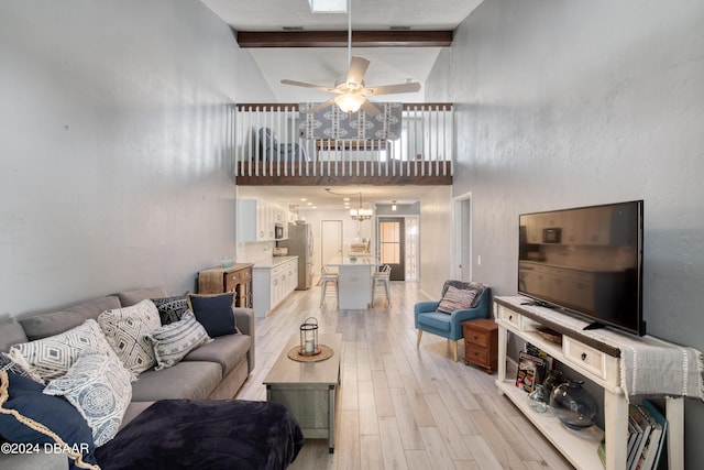 living room featuring beam ceiling, high vaulted ceiling, light hardwood / wood-style floors, and ceiling fan with notable chandelier