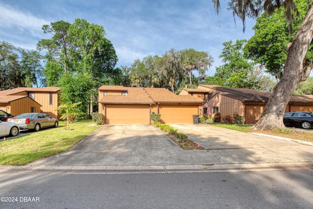 view of front of house featuring a garage and a front lawn