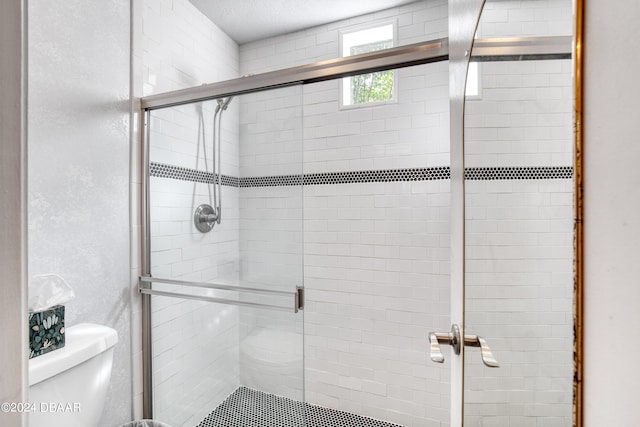 bathroom featuring a shower with door