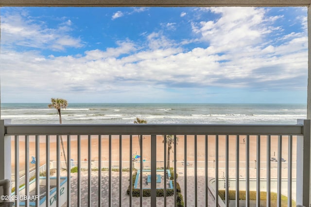 exterior space featuring a beach view and a water view