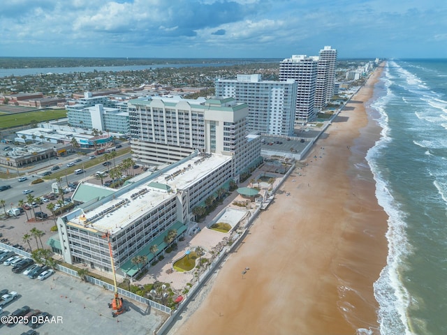 aerial view with a water view, a view of city, and a beach view