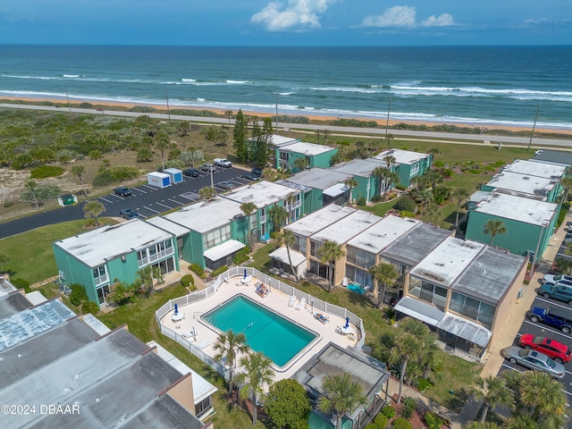 birds eye view of property featuring a beach view and a water view