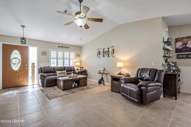 living room with ceiling fan, vaulted ceiling, and light tile patterned floors