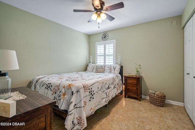 bedroom with ceiling fan and a closet