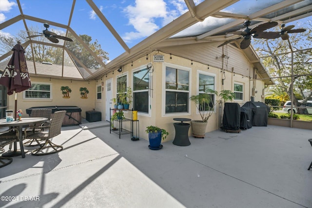 exterior space with a lanai, ceiling fan, a patio, and a hot tub