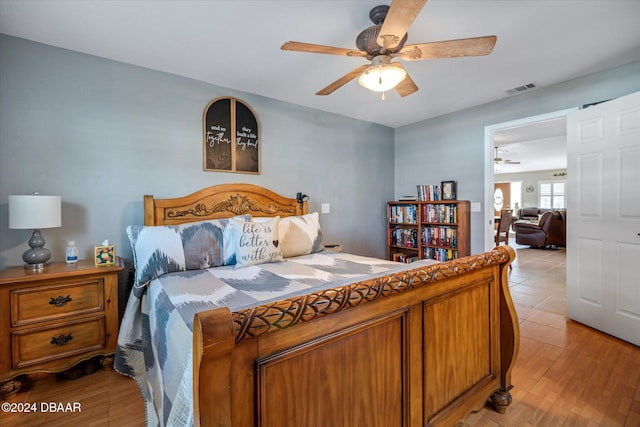 bedroom with light wood-type flooring and ceiling fan