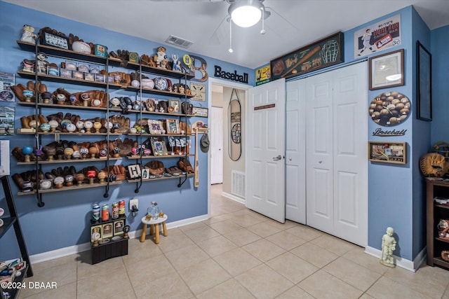 interior space featuring ceiling fan and light tile patterned floors