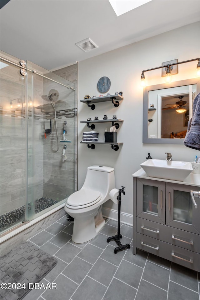 bathroom with walk in shower, tile patterned flooring, vanity, and toilet