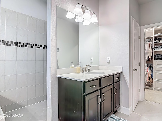 200 Azure Mist Way, Daytona Beach, FL 32124 - bathroom featuring a walk in closet, vanity, and tile patterned flooring