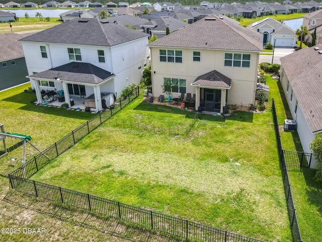 200 Azure Mist Way, Daytona Beach, FL 32124 - back of property with stucco siding, a residential view, a patio area, roof with shingles, and central AC