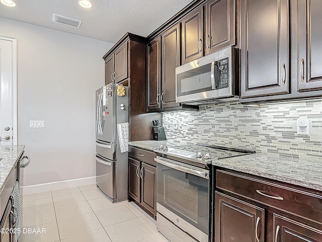 200 Azure Mist Way, Daytona Beach, FL 32124 - kitchen featuring appliances with stainless steel finishes, light stone counters, light tile patterned floors, tasteful backsplash, and a textured ceiling