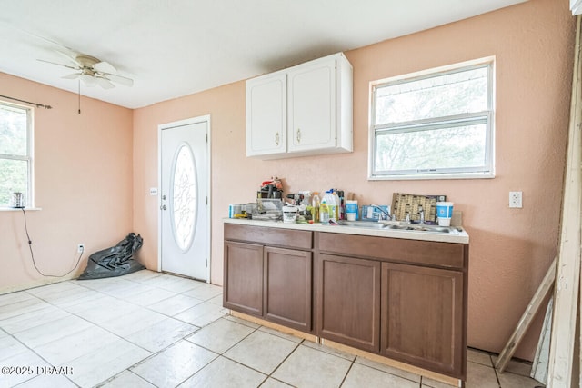 3304 India Palm Dr, Edgewater, FL 32141 - kitchen featuring light countertops, a ceiling fan, white cabinets, and light tile patterned floors
