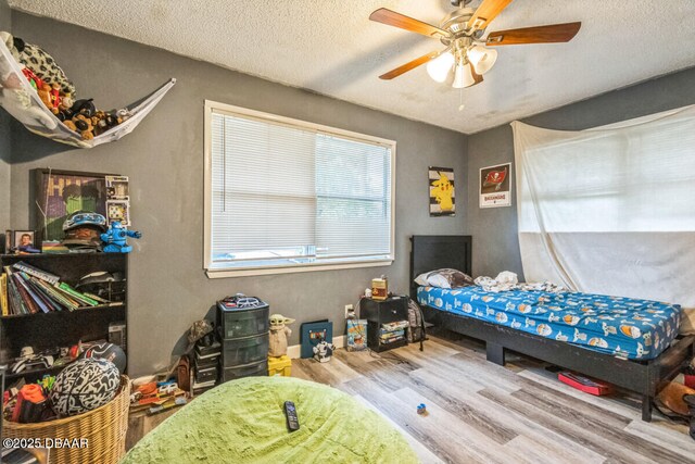 3304 India Palm Dr, Edgewater, FL 32141 - bedroom with wood finished floors, a textured ceiling, and ceiling fan