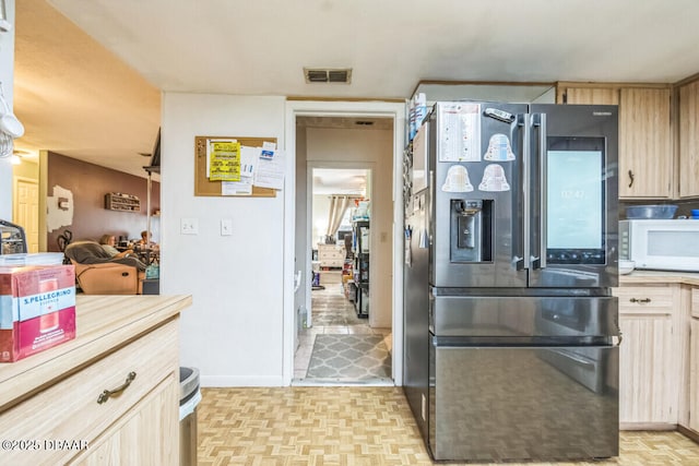 3304 India Palm Dr, Edgewater, FL 32141 - kitchen featuring stainless steel fridge, white microwave, light countertops, and light brown cabinets