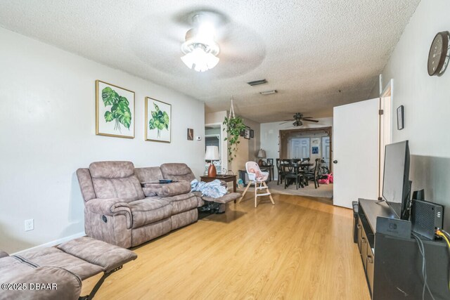 3304 India Palm Dr, Edgewater, FL 32141 - living room with ceiling fan, a textured ceiling, and light wood-type flooring