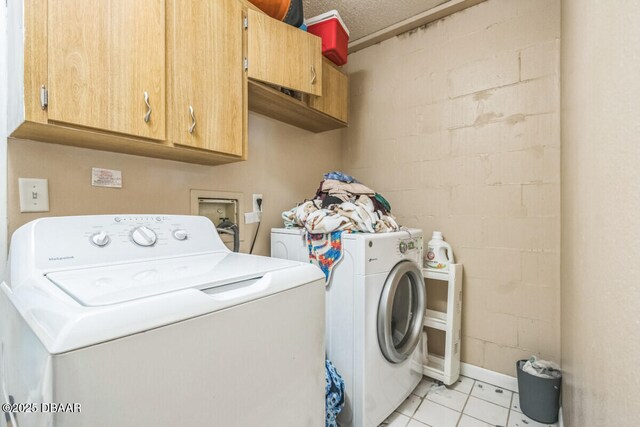 3304 India Palm Dr, Edgewater, FL 32141 - laundry room featuring cabinet space, independent washer and dryer, and light tile patterned floors