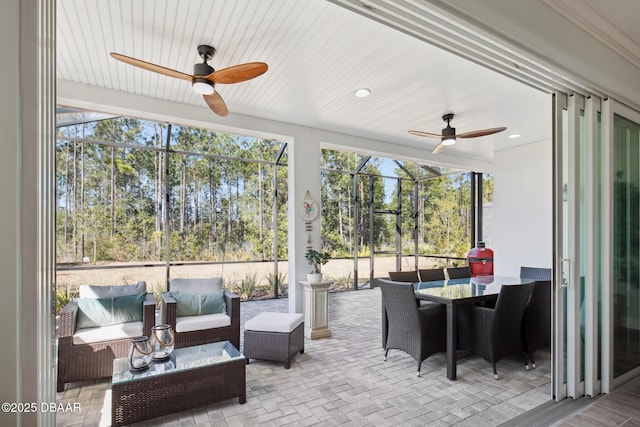 sunroom / solarium with ceiling fan and a healthy amount of sunlight