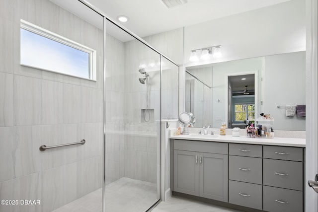 bathroom featuring vanity and a shower with door