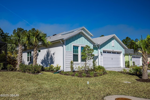 view of front of house with a garage and a front lawn