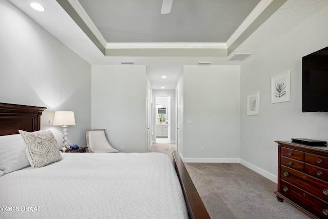 carpeted bedroom with crown molding, ceiling fan, and a raised ceiling