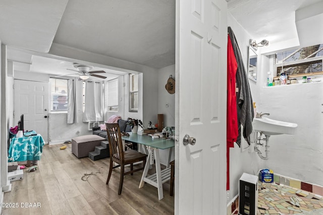 interior space featuring sink, light hardwood / wood-style floors, and ceiling fan