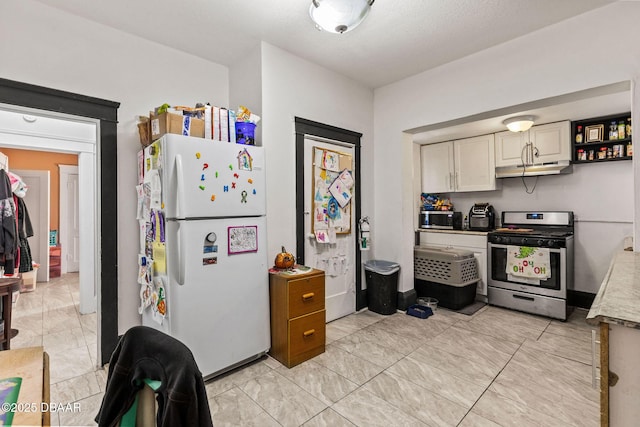 kitchen with gas range and white fridge