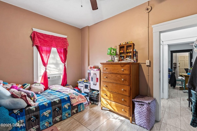 bedroom with cooling unit and ceiling fan