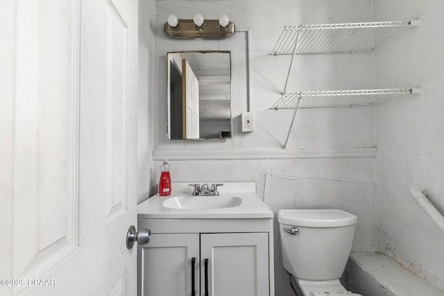 bathroom featuring vanity and toilet