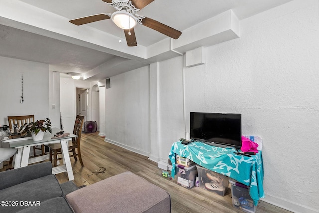 living room featuring hardwood / wood-style flooring and ceiling fan