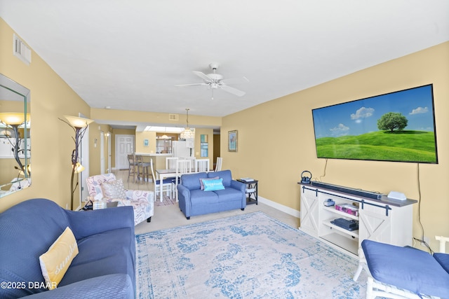 living room with ceiling fan and carpet flooring