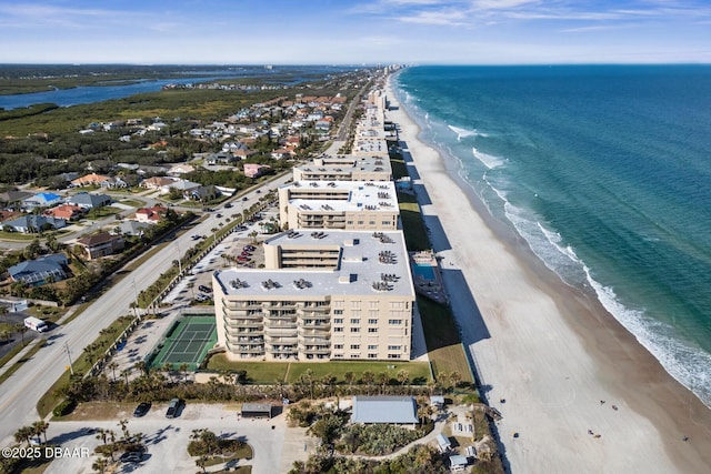 drone / aerial view featuring a view of the beach and a water view