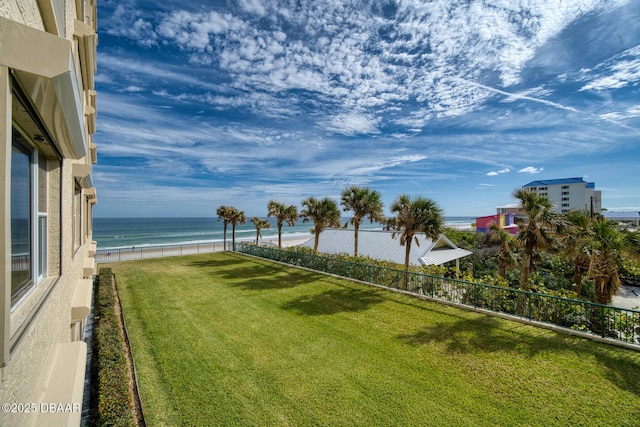 view of yard featuring a water view and a view of the beach