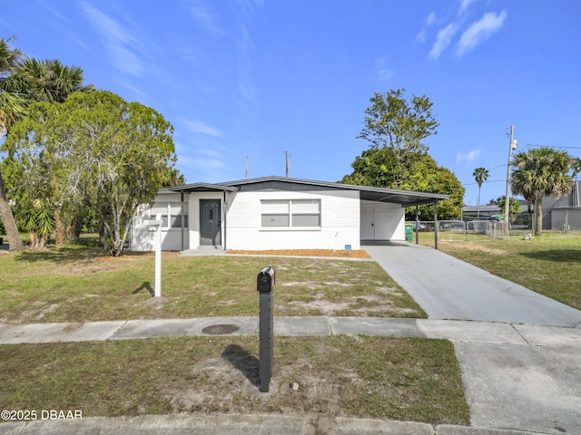 single story home featuring a carport and a front lawn